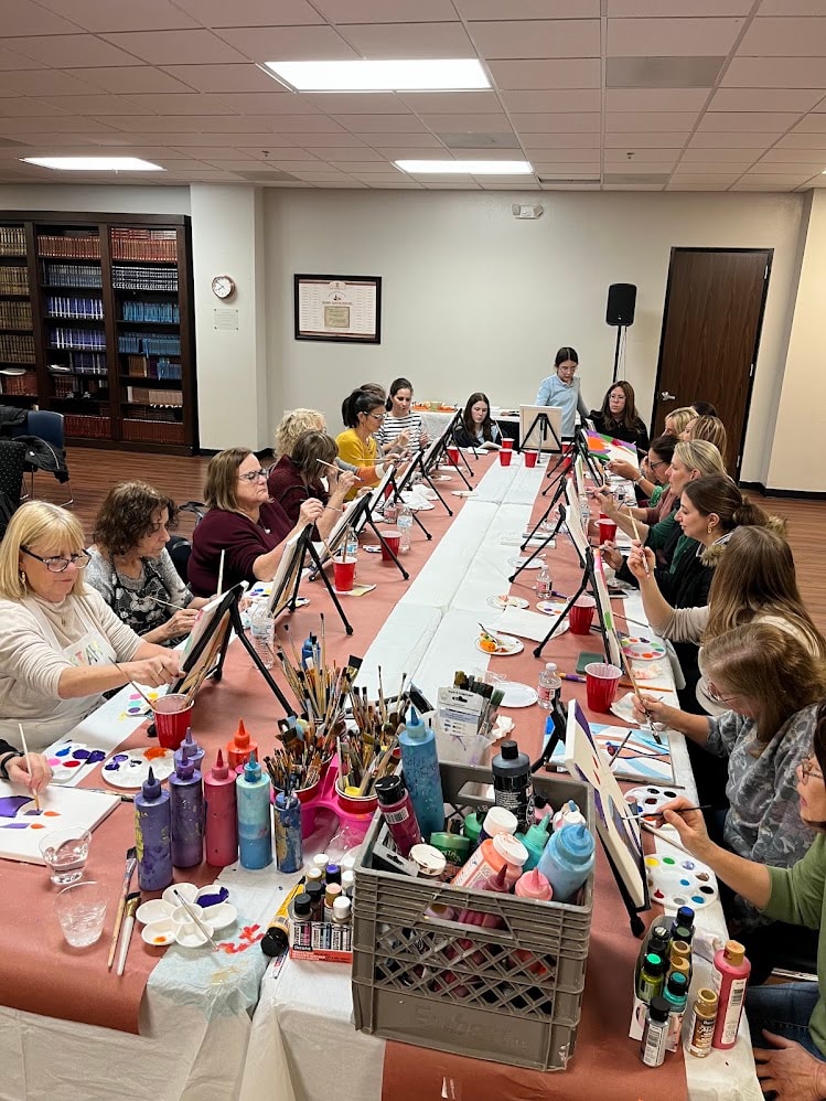 Full room view of painting party class in session